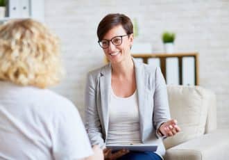Successful psychologist talking to her patient